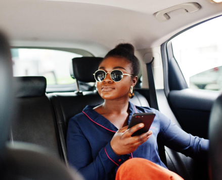 person-in-car-holding-phone